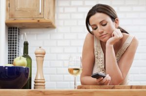 Smiling woman with cell phone as she learns to flirt with a Virgo man via text message