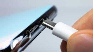 Man connecting USB Type C Port Cable for charging to the smartphone. Close up photo.