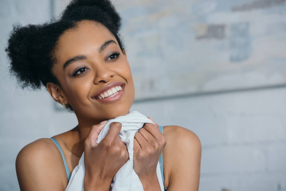 African-American women wear afro-puff hairstyle on natural curly hair