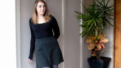 Woman wearing black long sleeve top and a polka dot skirt with blue tights