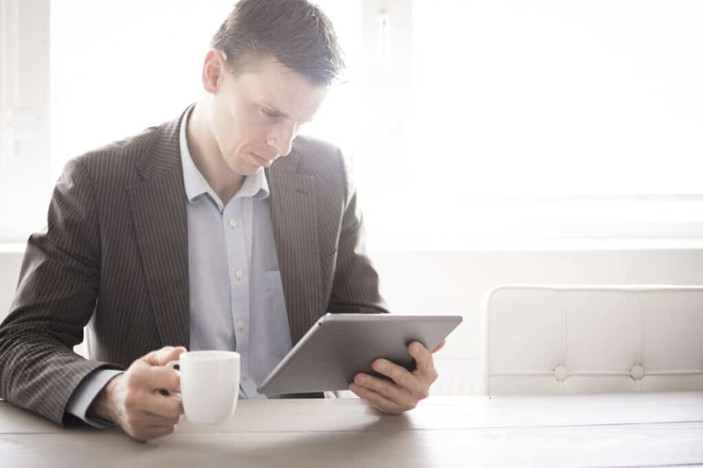 businessman reading on tablet