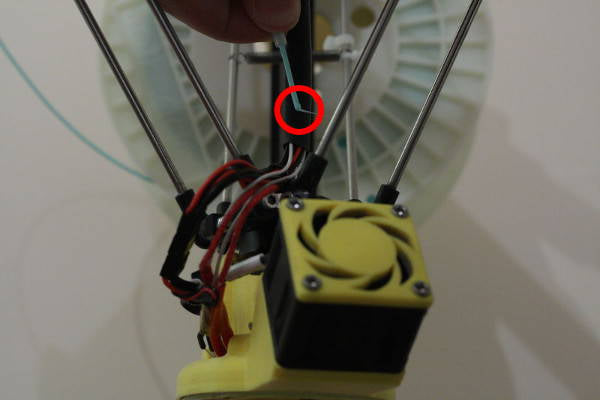 Secure the filament by threading it through the hole in the spool holder