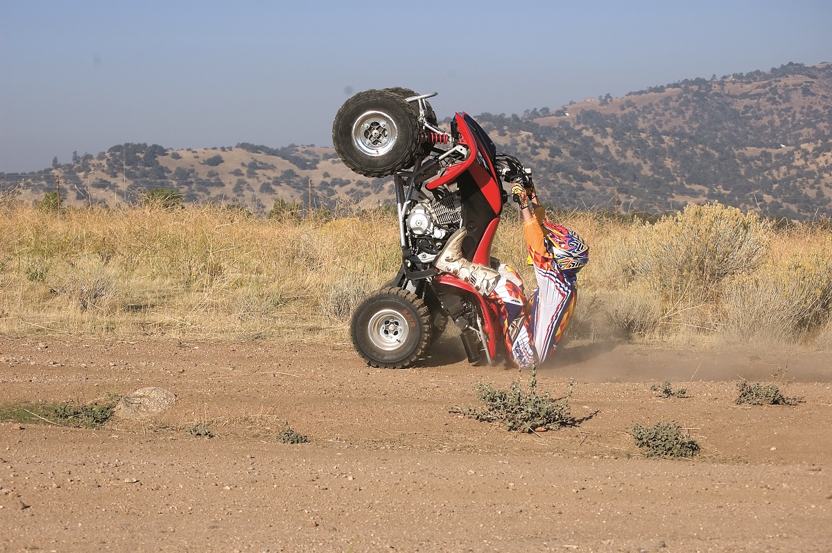 Beau uses his wheel control to launch his ATV over this rocky drop, keeping the front end of the vehicle ahead and above the obstacle.