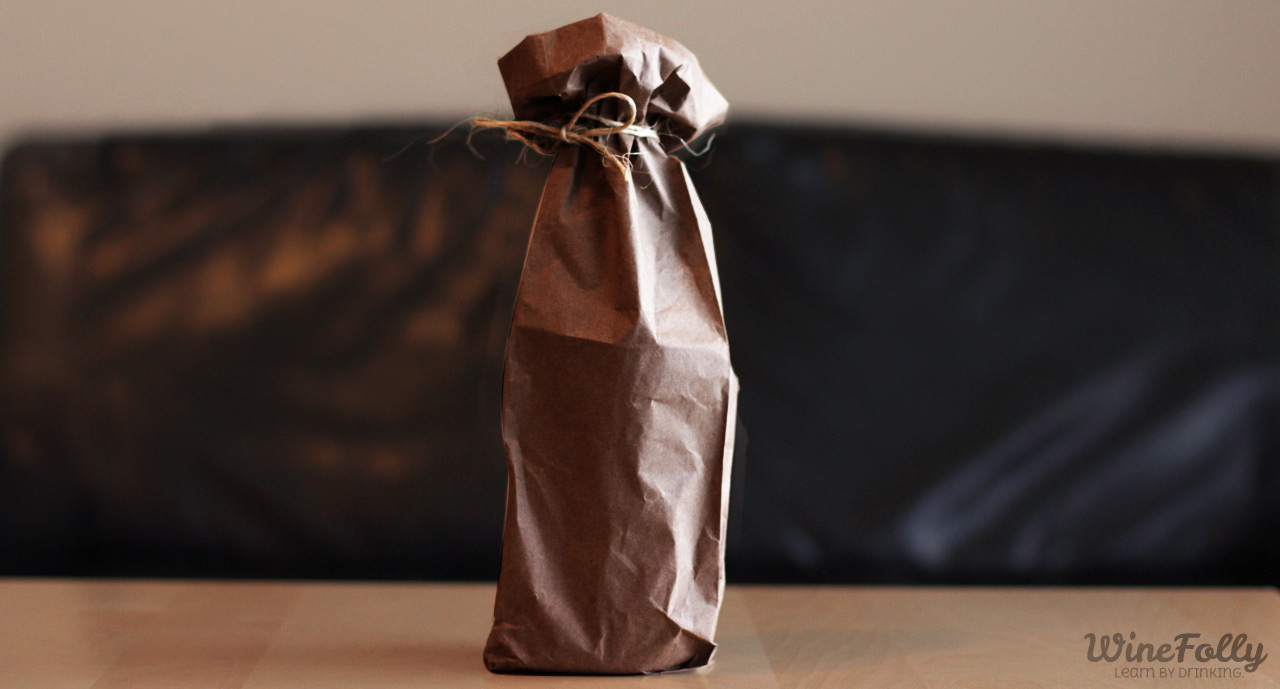 Wine bottles in paper bags tied with strings for tasting