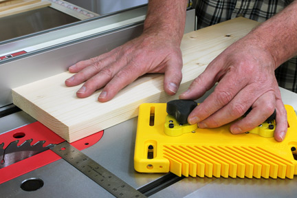 Place the feather board on the table saw before cutting
