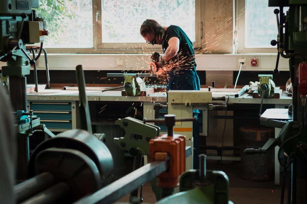 Man cutting metal with angle grinder