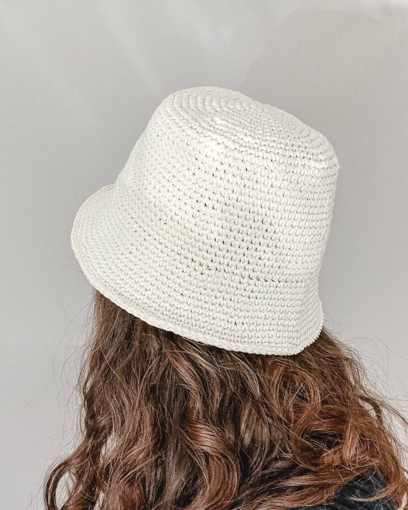 women with brown hair wearing cream colored crochet bucket hat