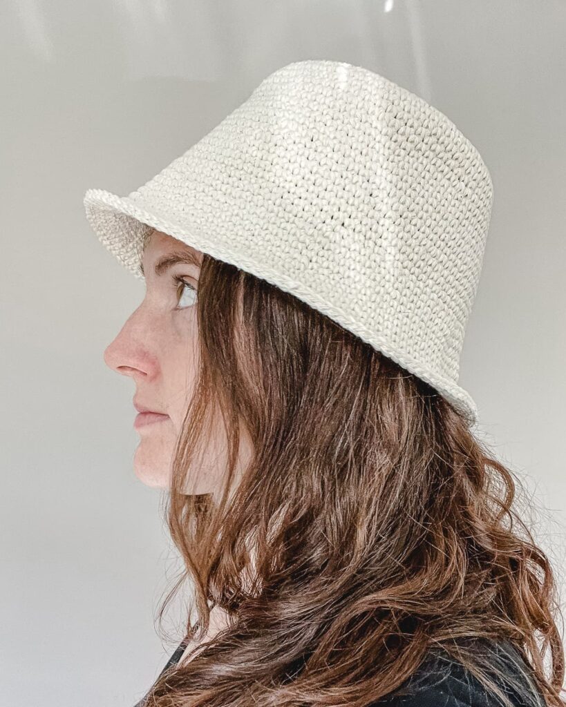 cotton crochet bcuket hat on a gray surface with a light background