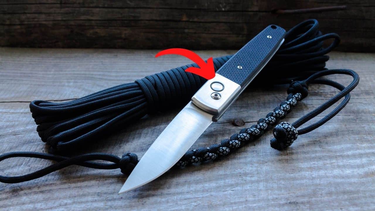 button lock folding knife with a red arrow pointing to the release