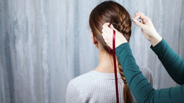 Add ribbons to braids with topsy tails