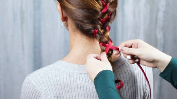 Weaving ribbons into brown hair