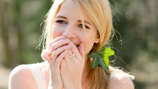 woman with hair leaves herself surprised