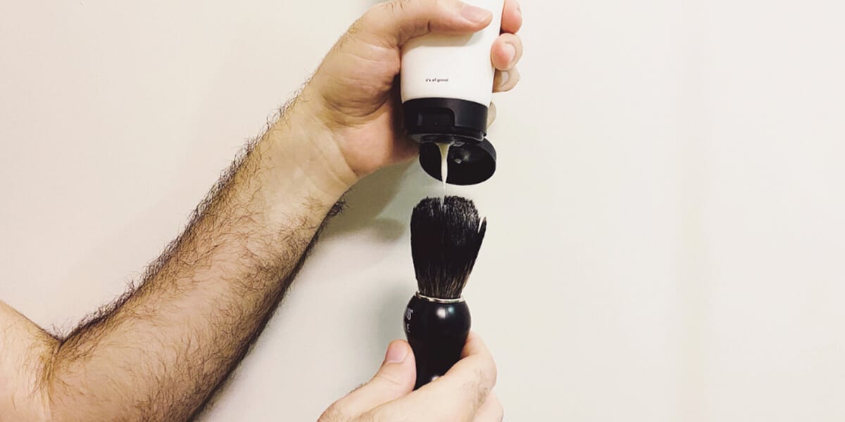 beard brush with shaving cream on bristles