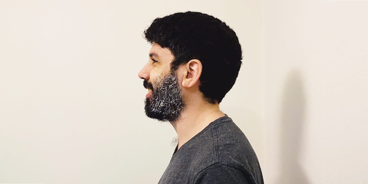 man with shaving cream lathered in beard