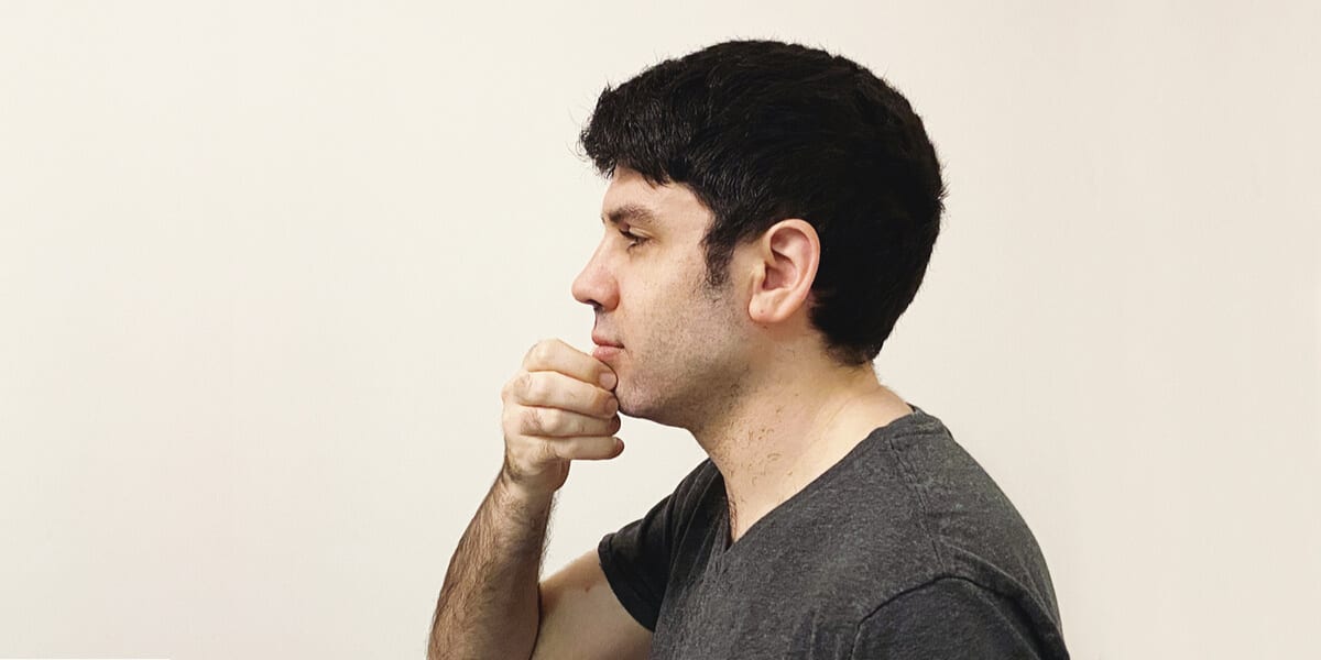 man touching freshly shaved face