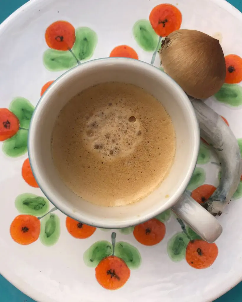 Image of magic mushrooms next to a cup of tea.